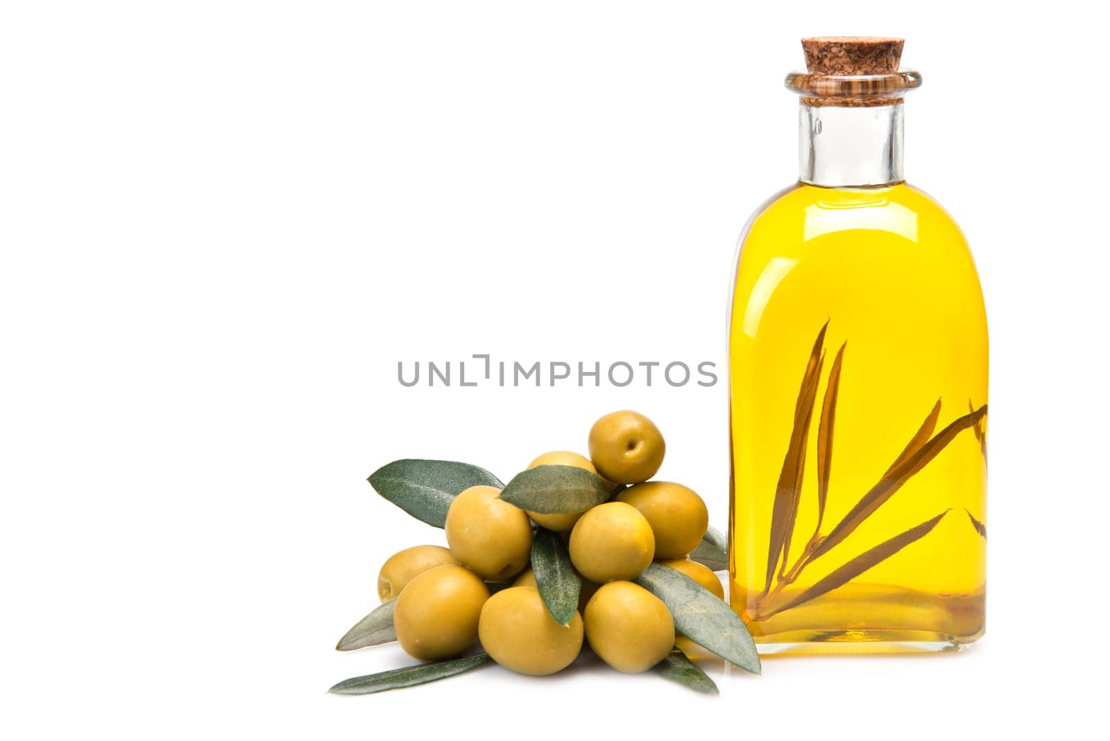 A jar with olive oil and some green olives isolated over a white background.