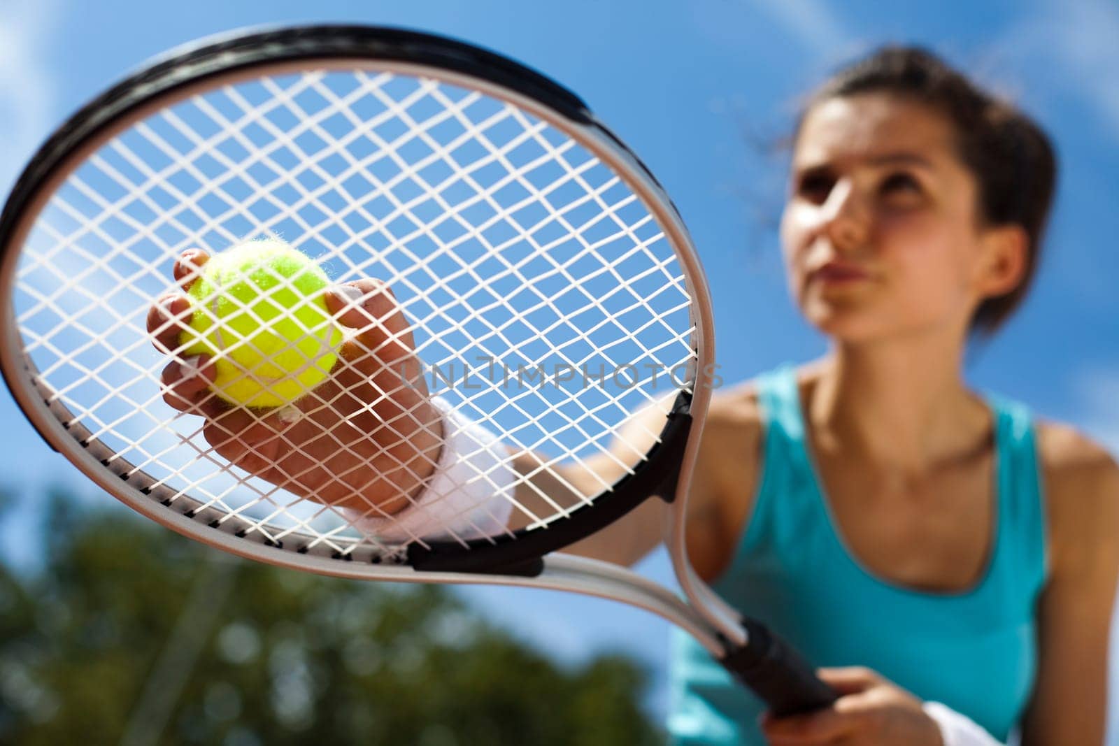 Young woman tennis player on the court