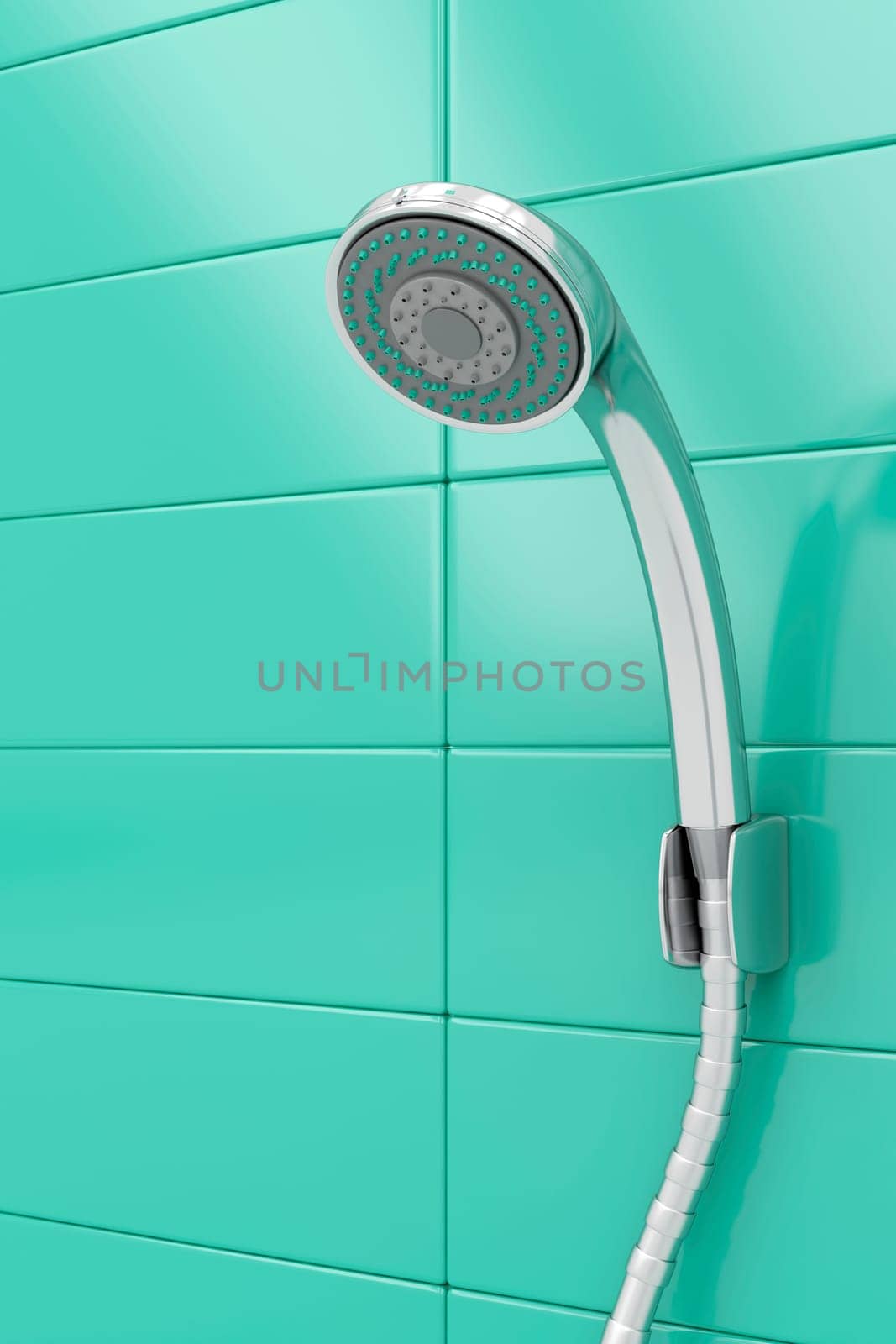 Chrome shower head on green tiles