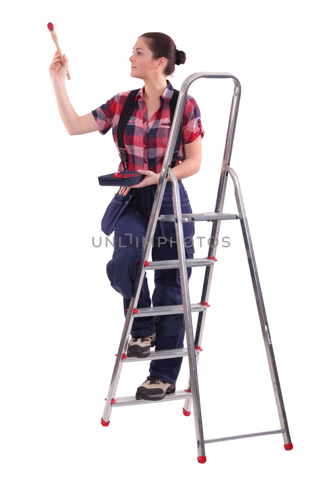 Female decorator climbing a ladder