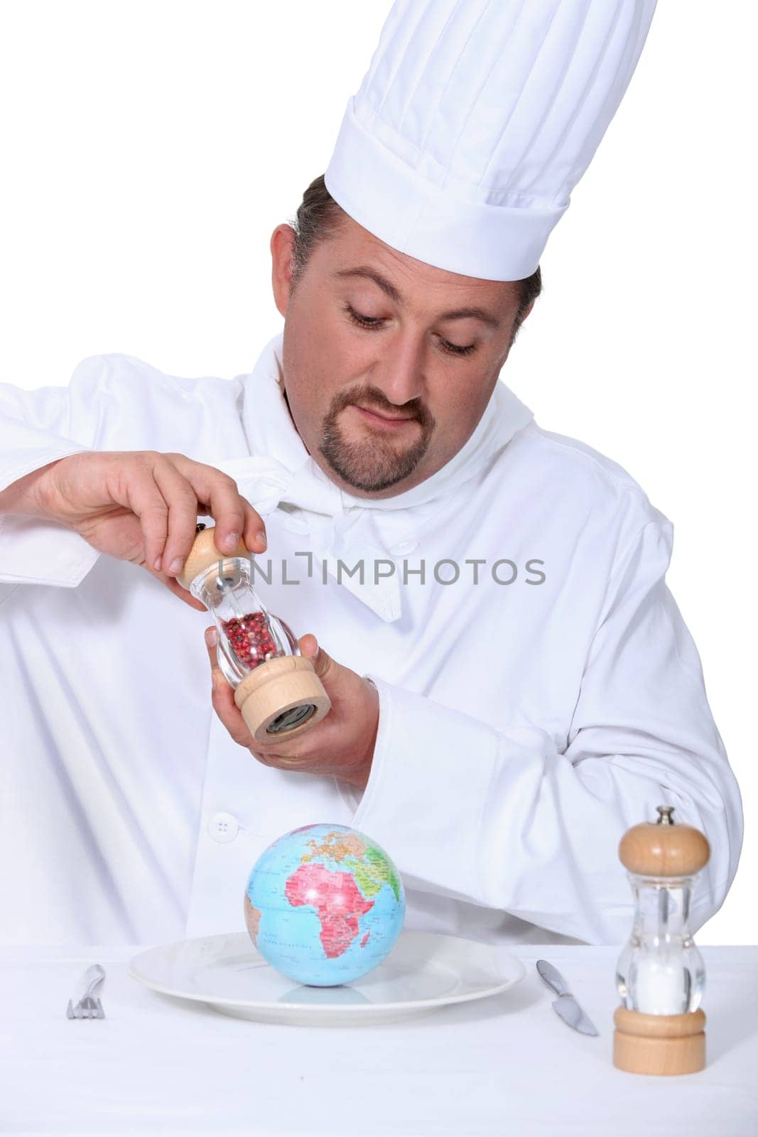 a cook seasoning a globe