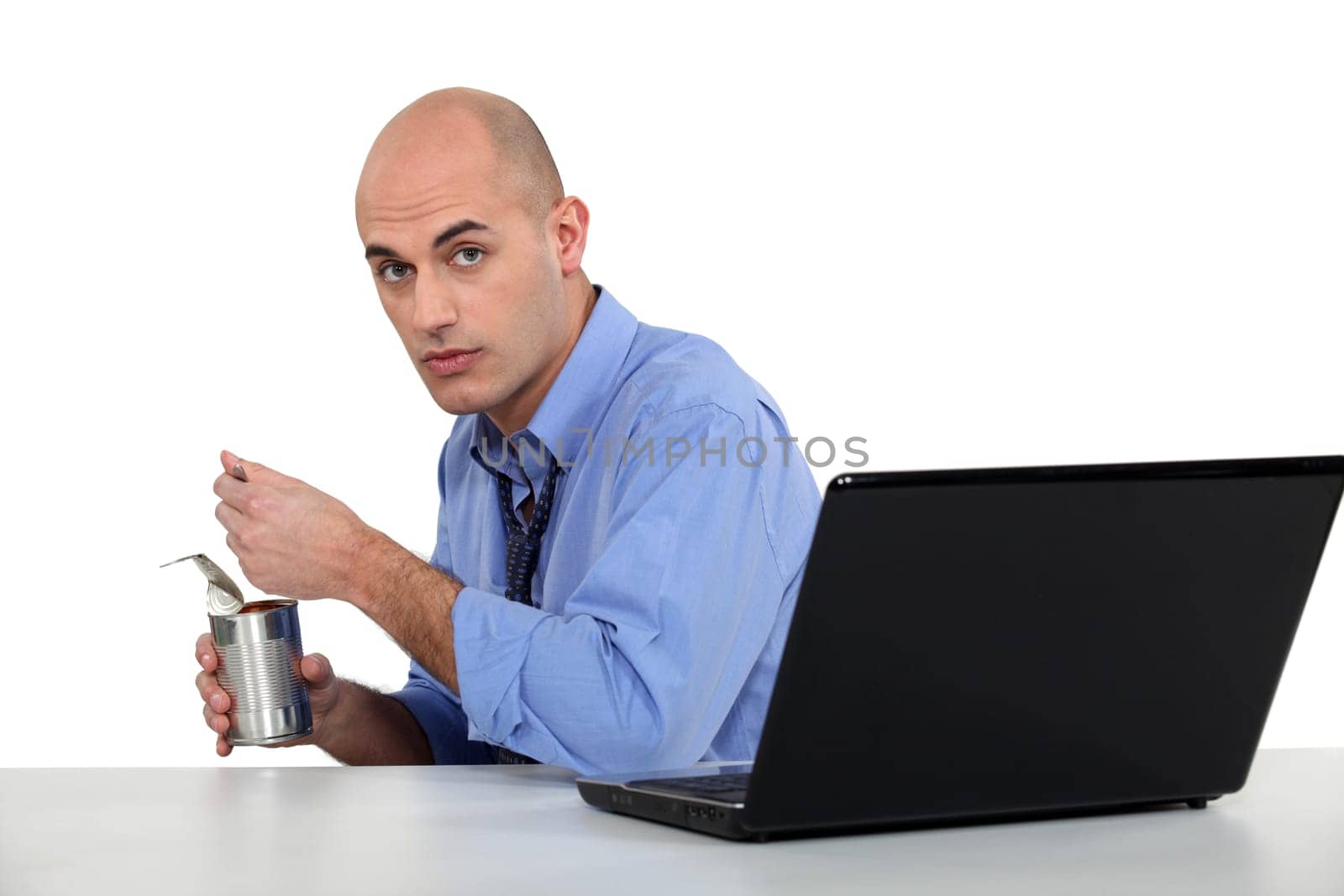 executive eating out of tin can