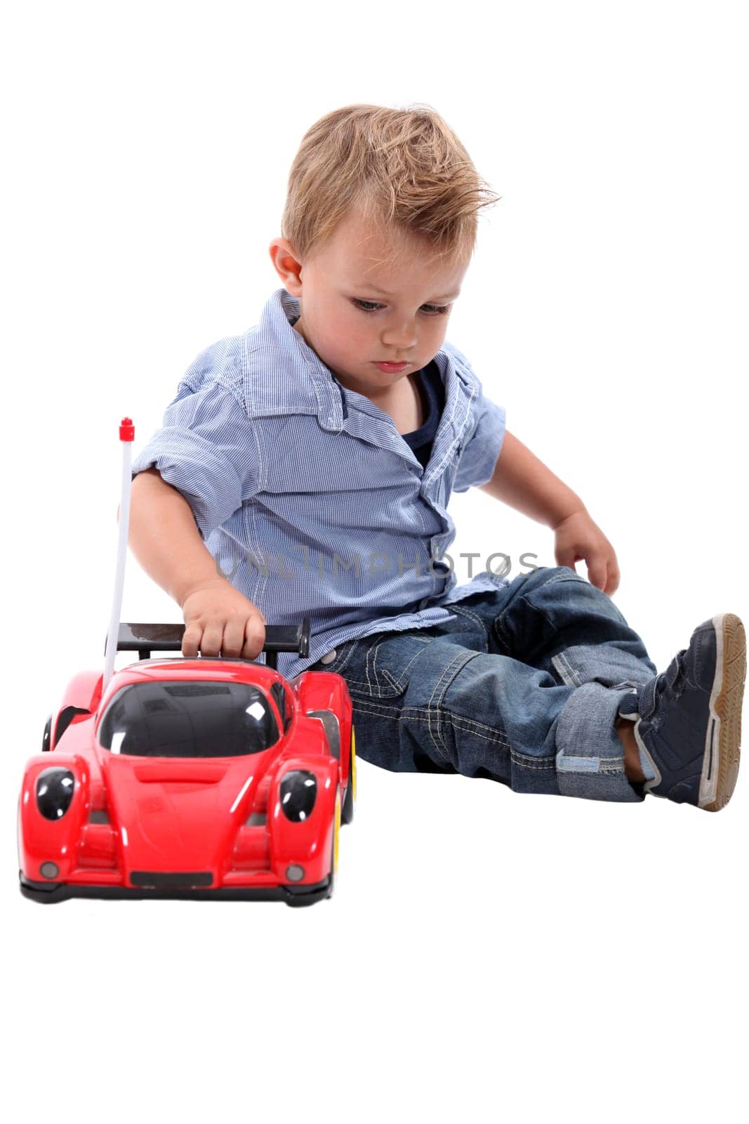 Young boy playing with a toy car