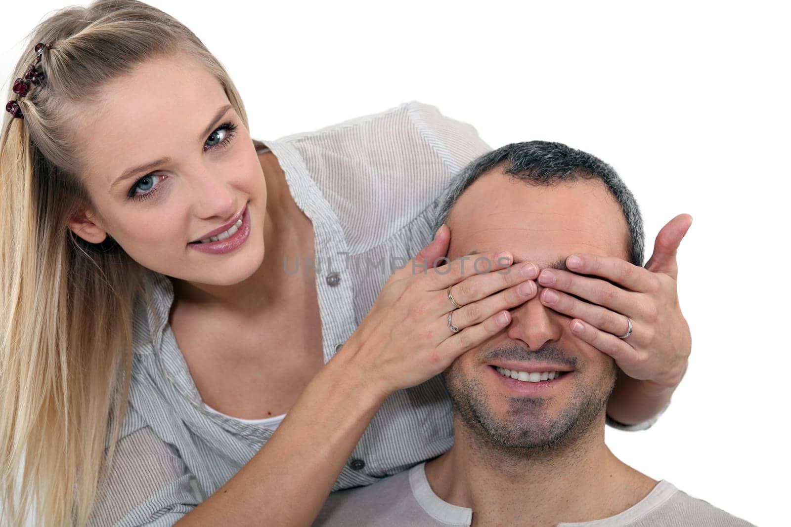 Woman covering a man's eyes