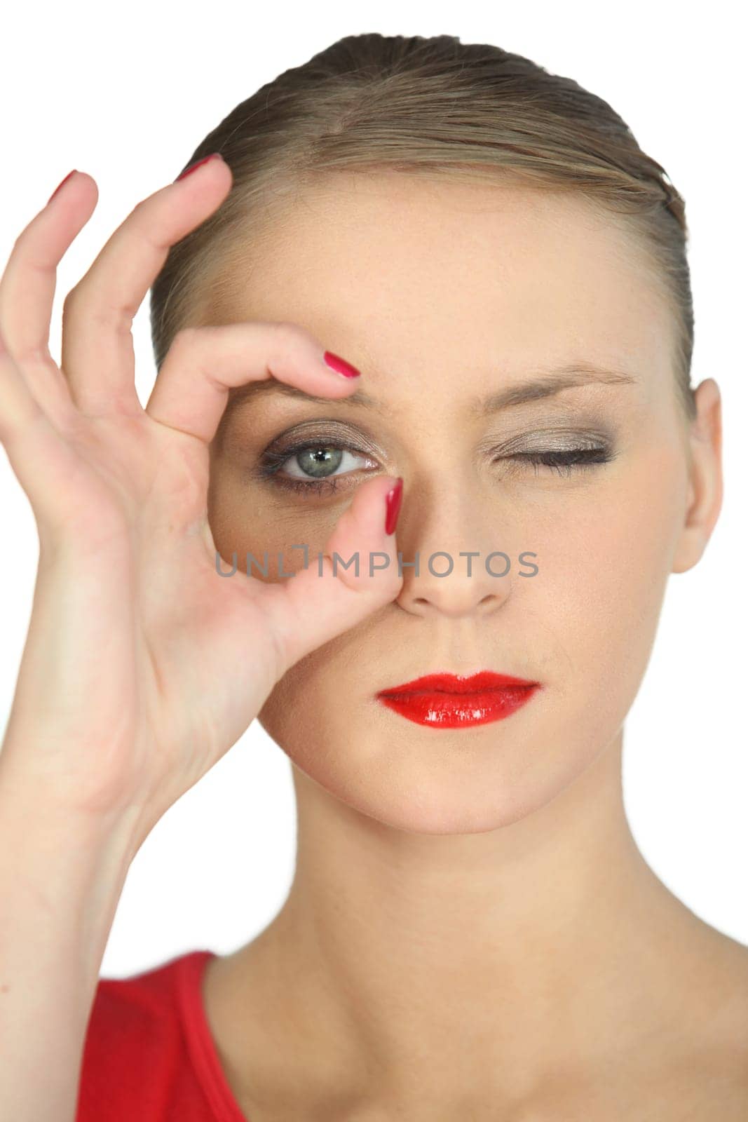Woman making a circle with her fingers around her eye