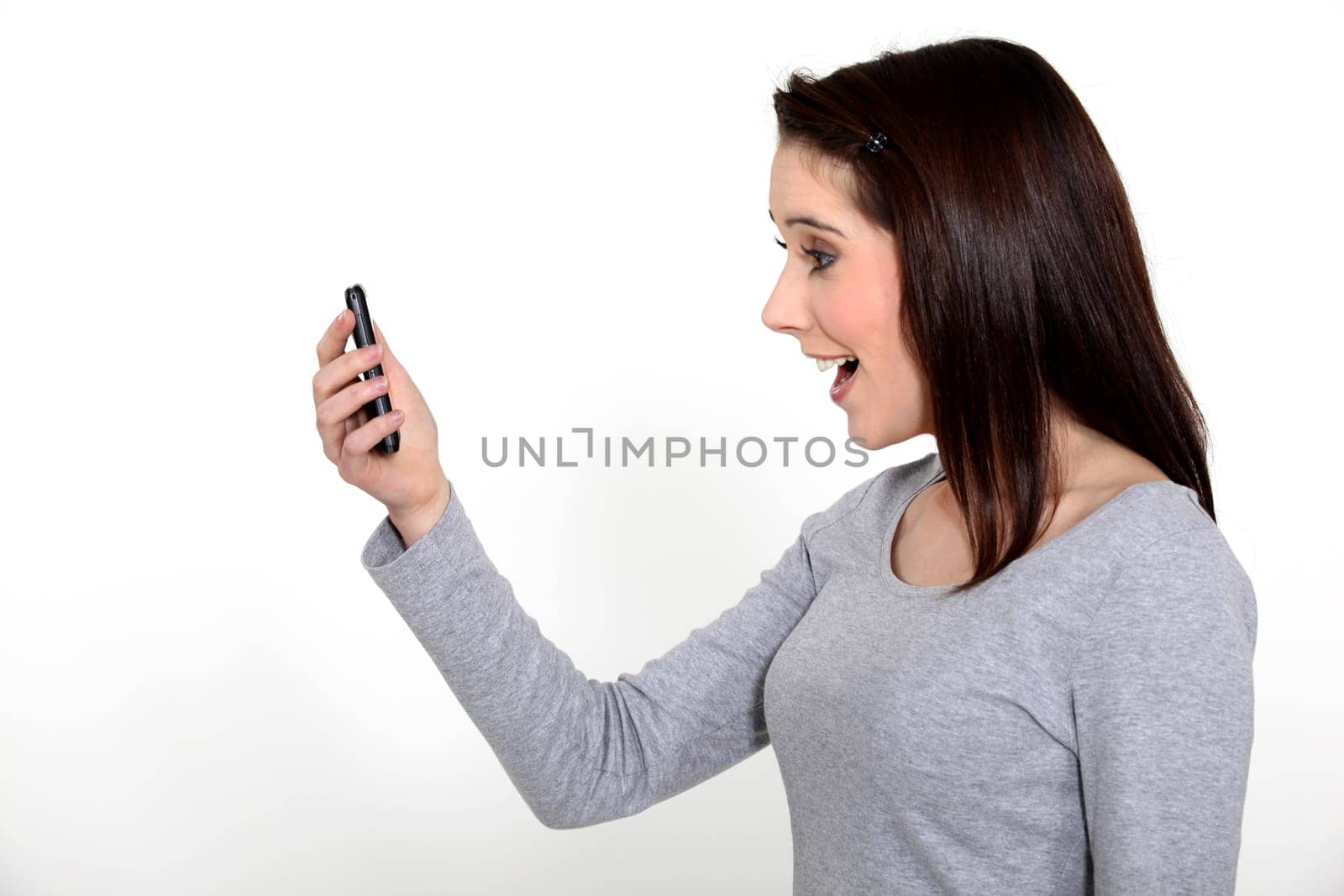 young woman receiving good news on her cell