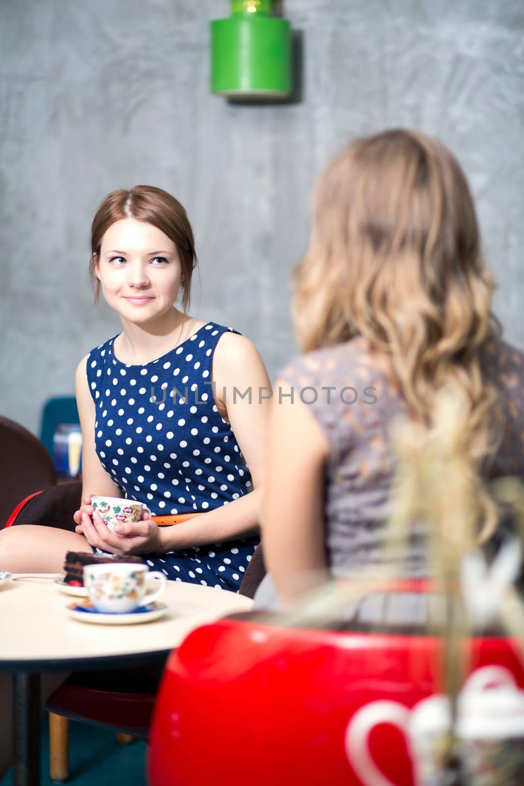 Two womans make dialogue and drinking hot coffee