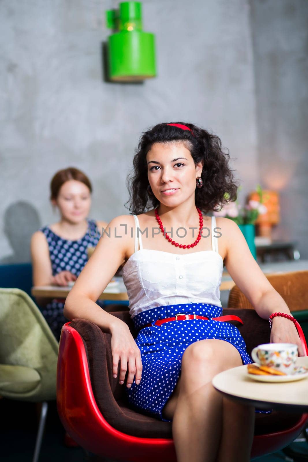Woman on chair in café with cheerful smile