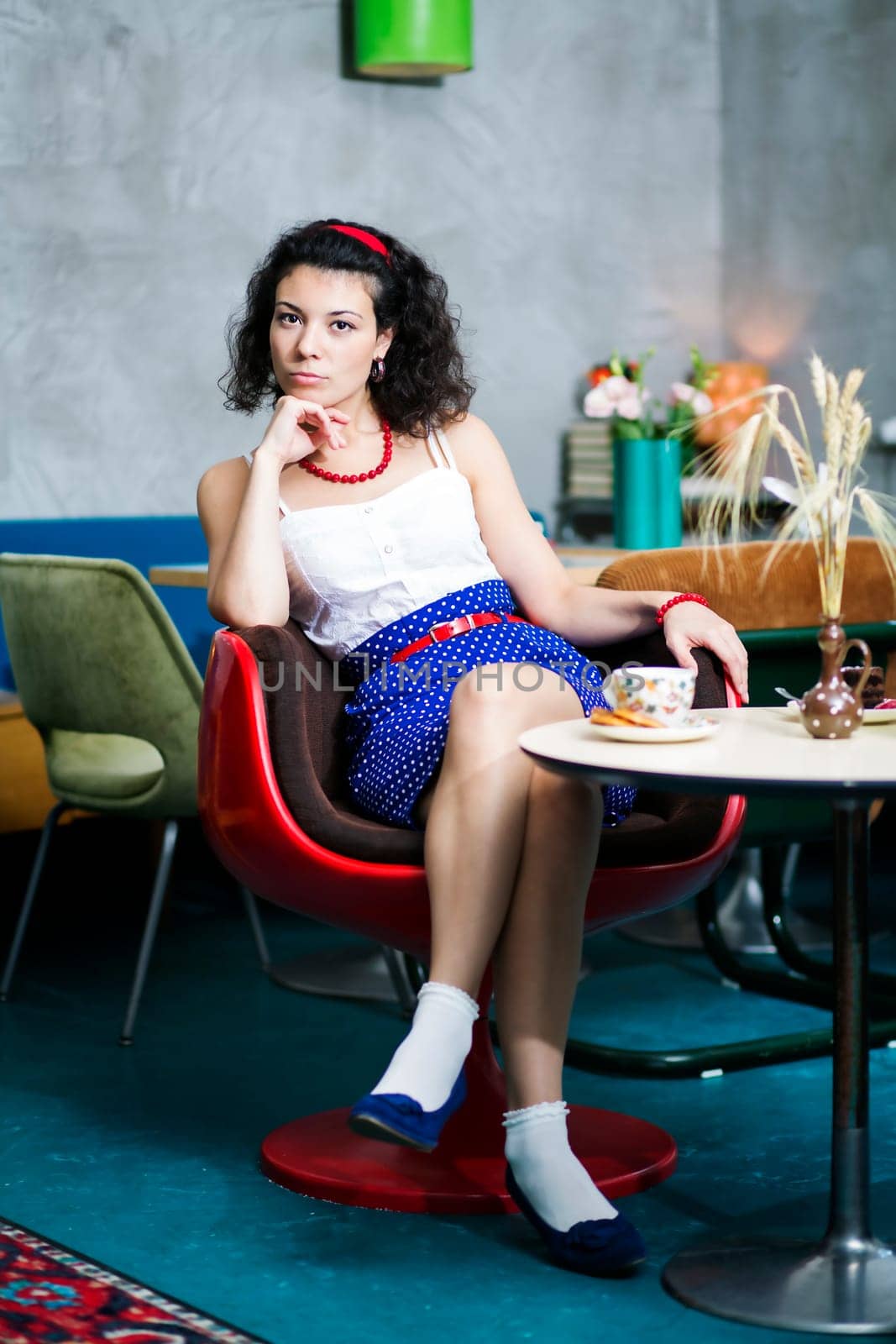 Woman on chair in café thinking about something