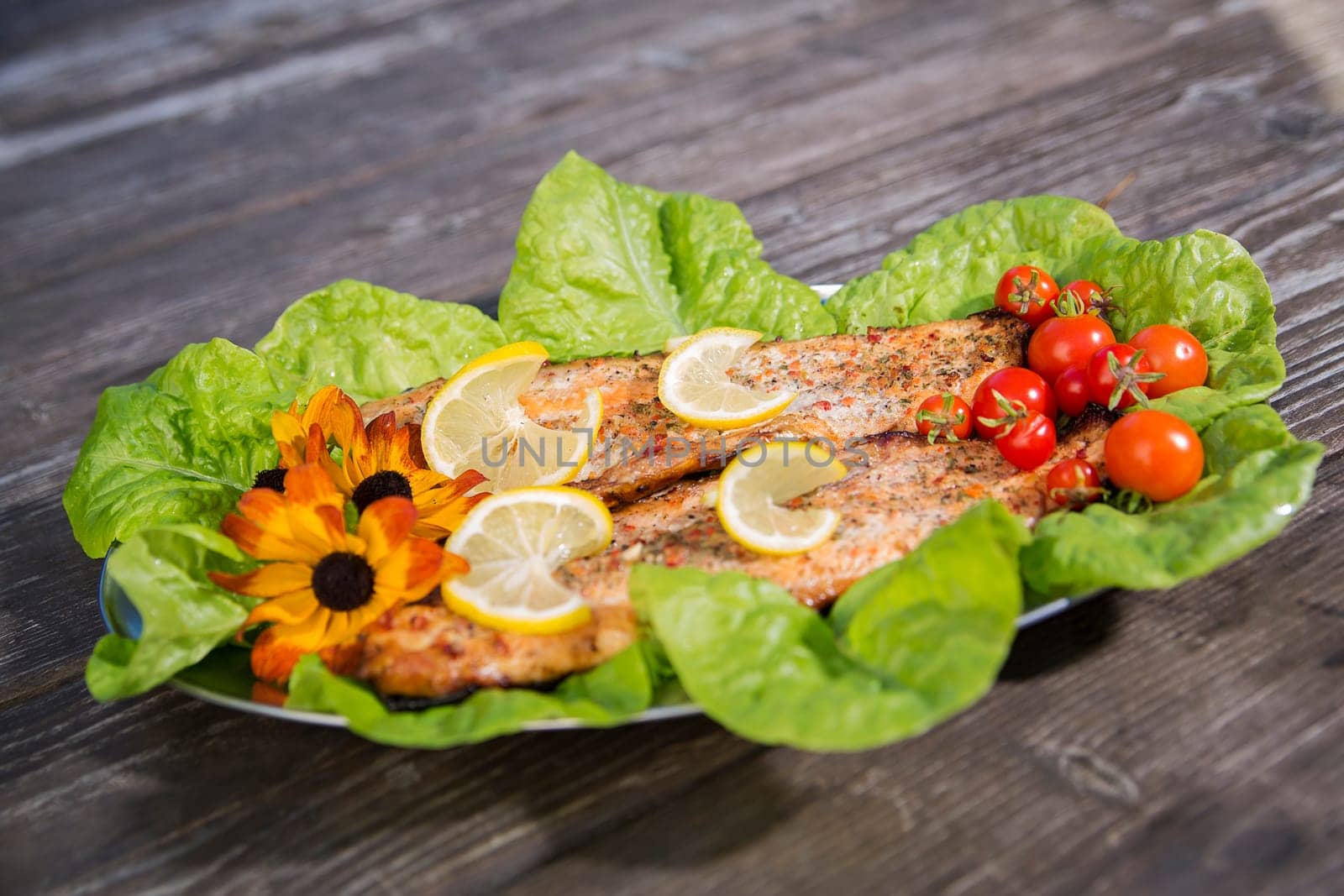 Baked fish slices with tomato and  green salad