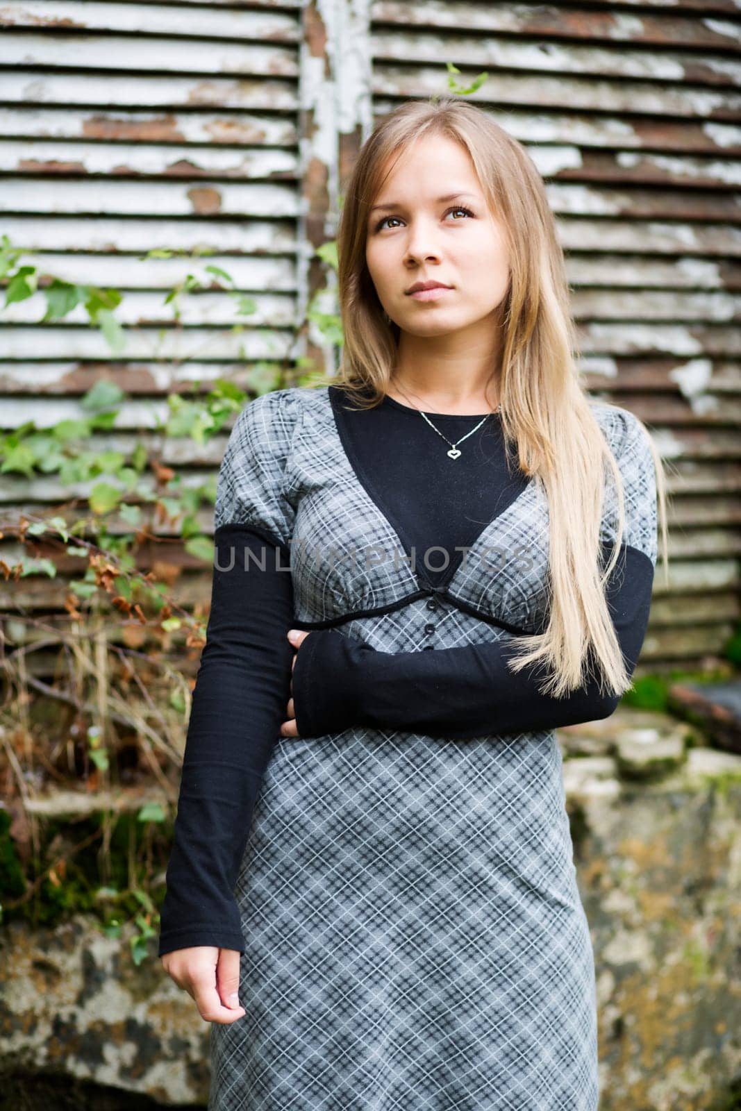 Young woman posing at camera and thinking something