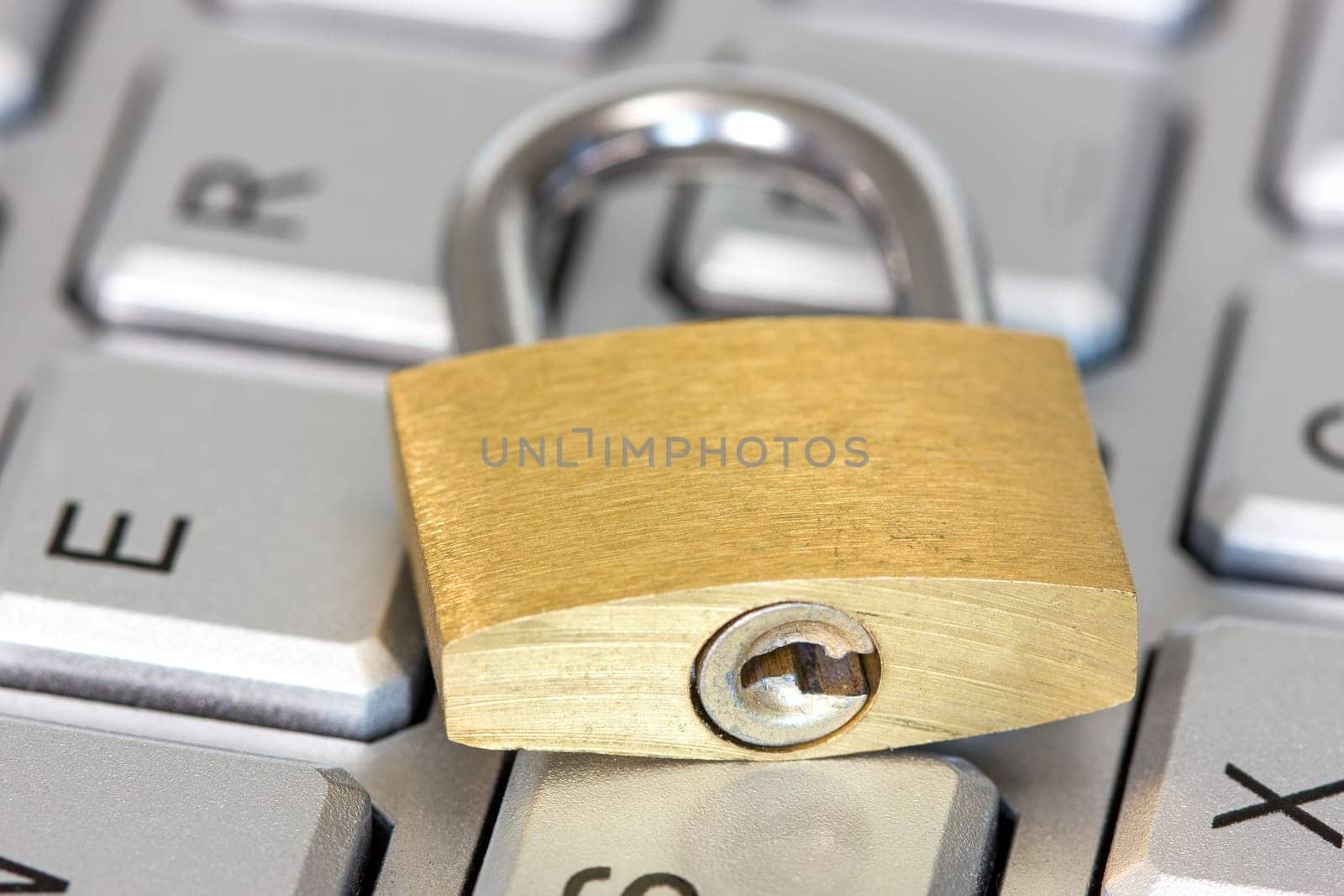 Concept of computer safety, golden lock on the keyboard