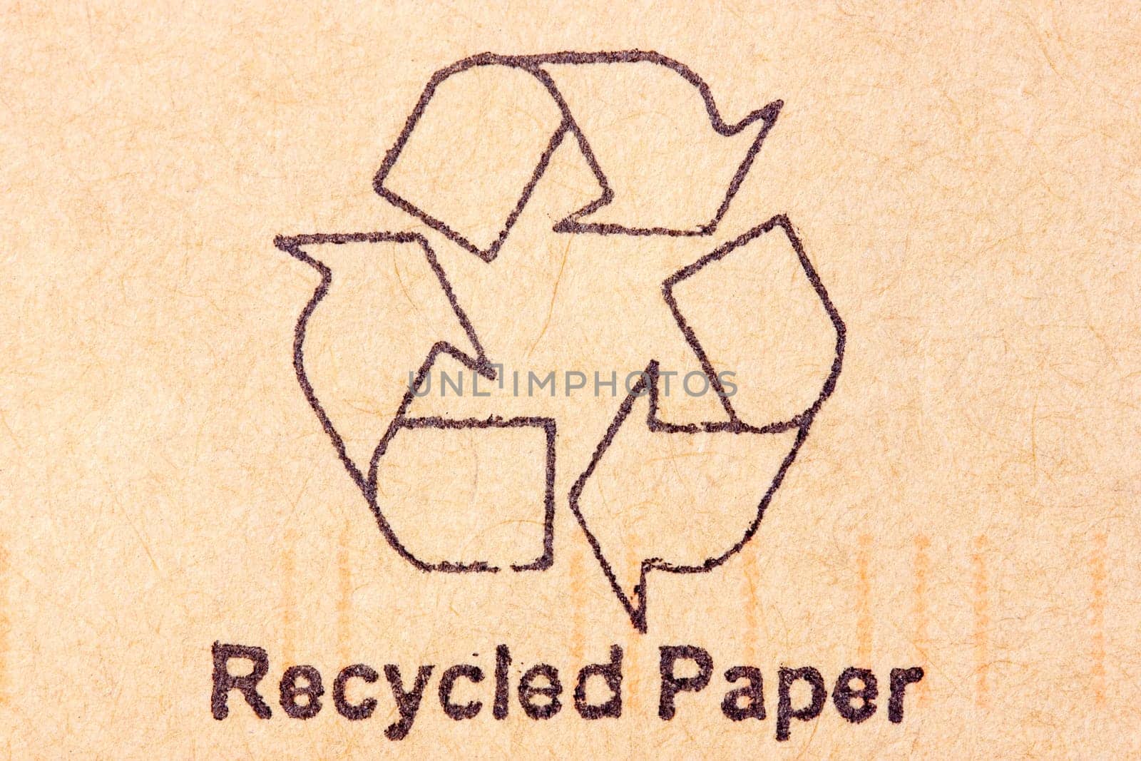 Brown recycled paper with black recycle symbol
