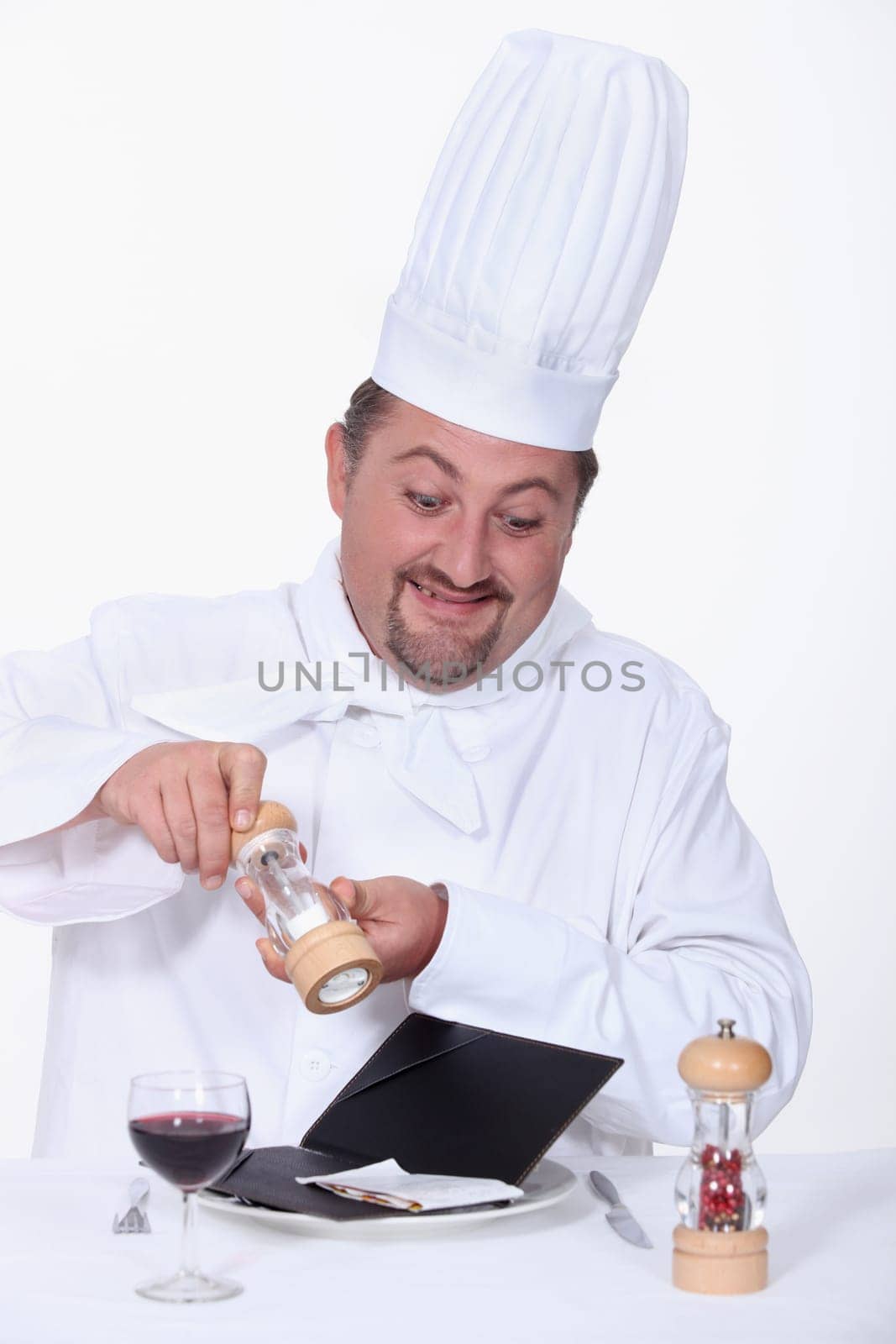 Chef seasoning the bill