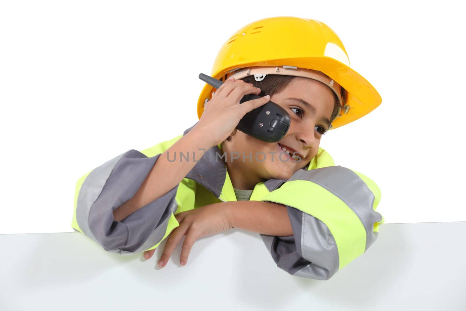 a little boy dressed in road man with a cell phone