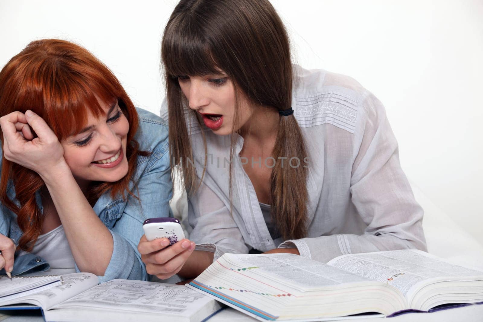 Friends laughing at a cellphone