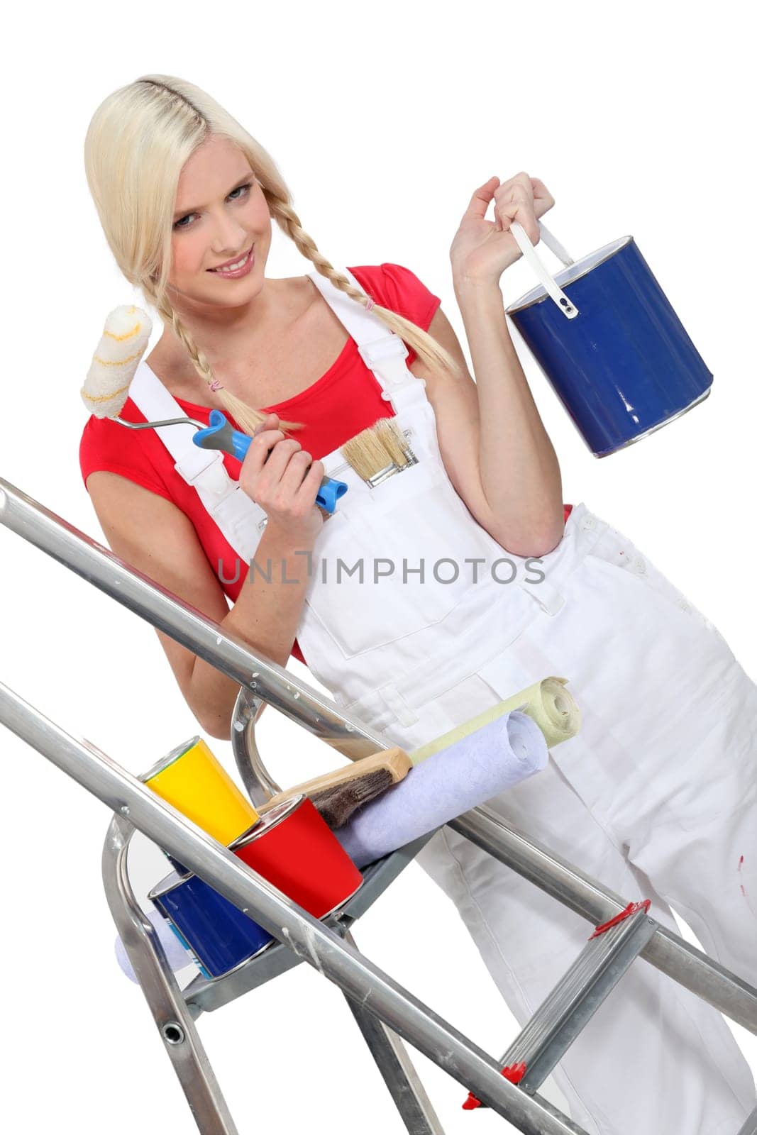 Young woman with plaits preparing to decorate in bright colours