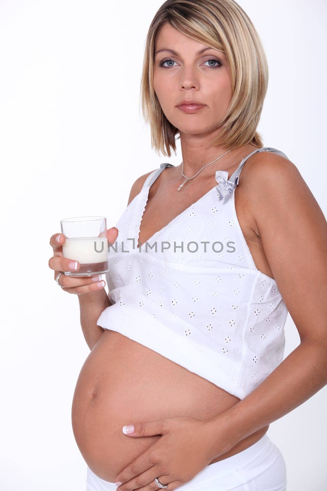 Pregnant woman with glass of milk
