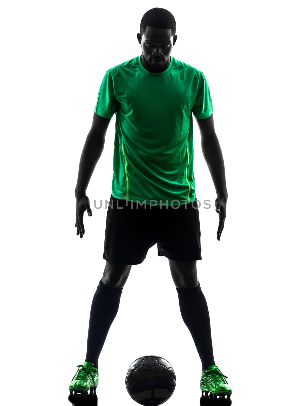 one african man soccer player green jersey standing in silhouette  on white background