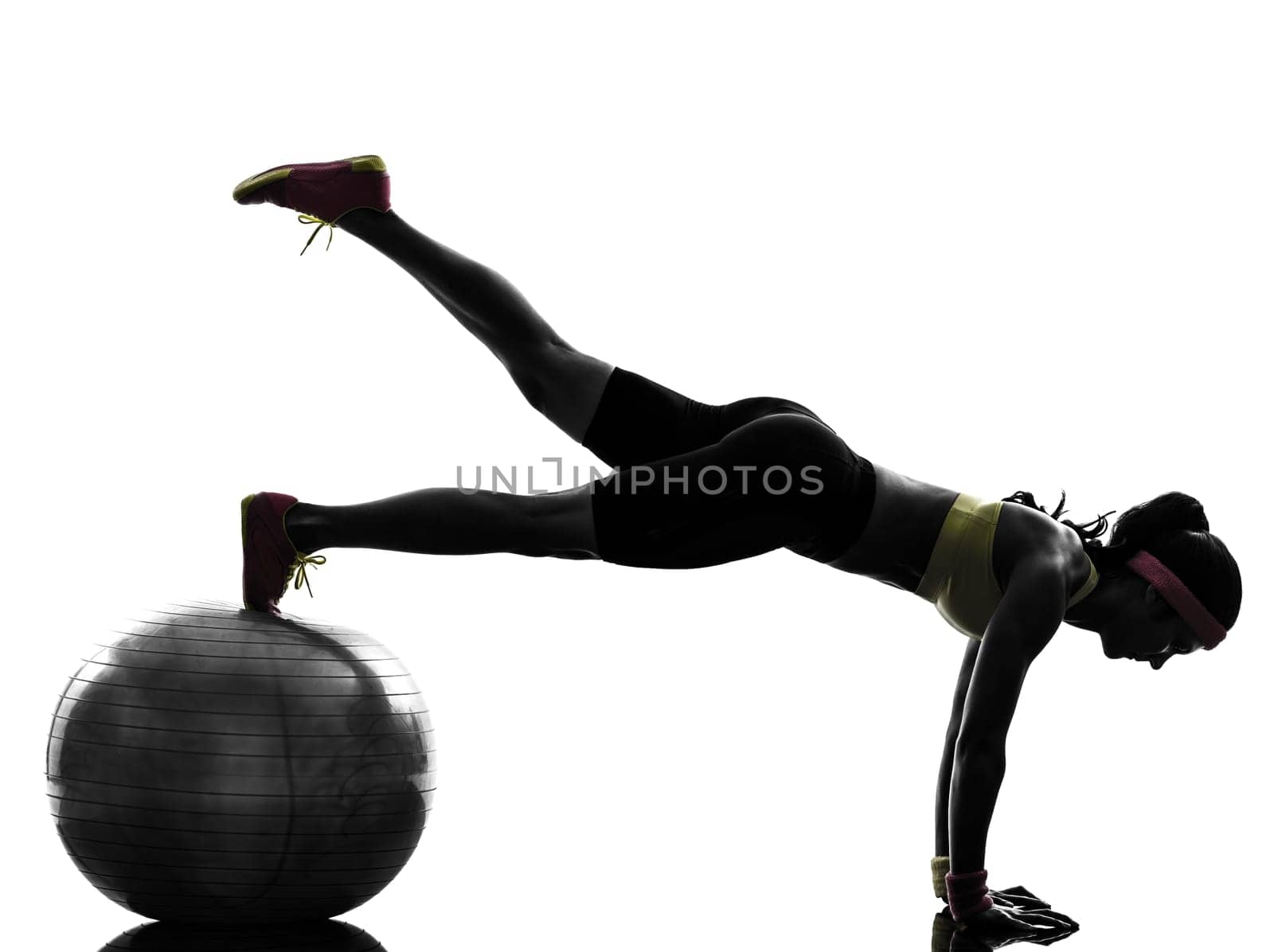 one  woman exercising fitness workout plank position on fitness ball in silhouette  on white background