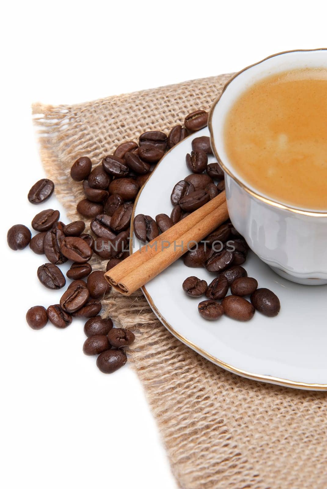Still life about coffee with a delicious  espresso and some coffee beans and cinnamon.