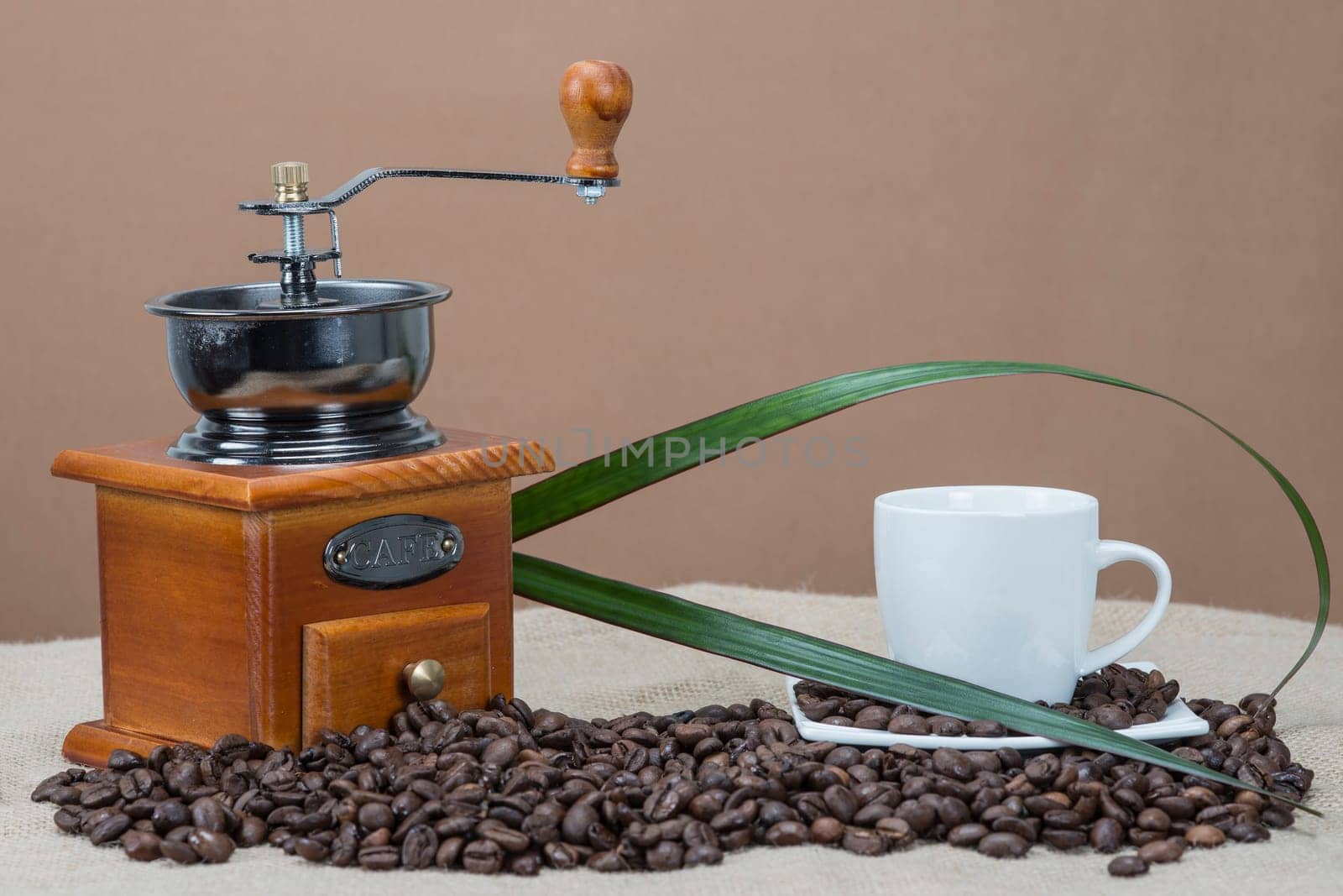 Still life about coffee with cups, beans and a mill