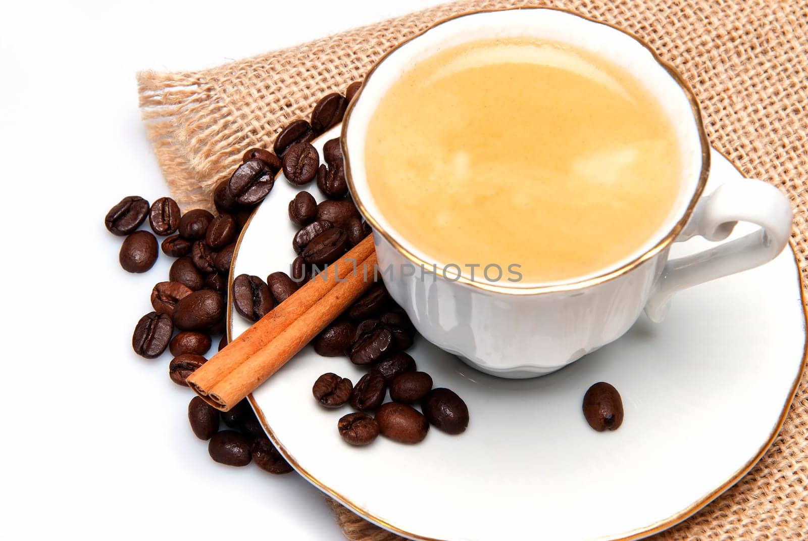 Still life about coffee with a delicious  espresso and some coffee beans and cinnamon.