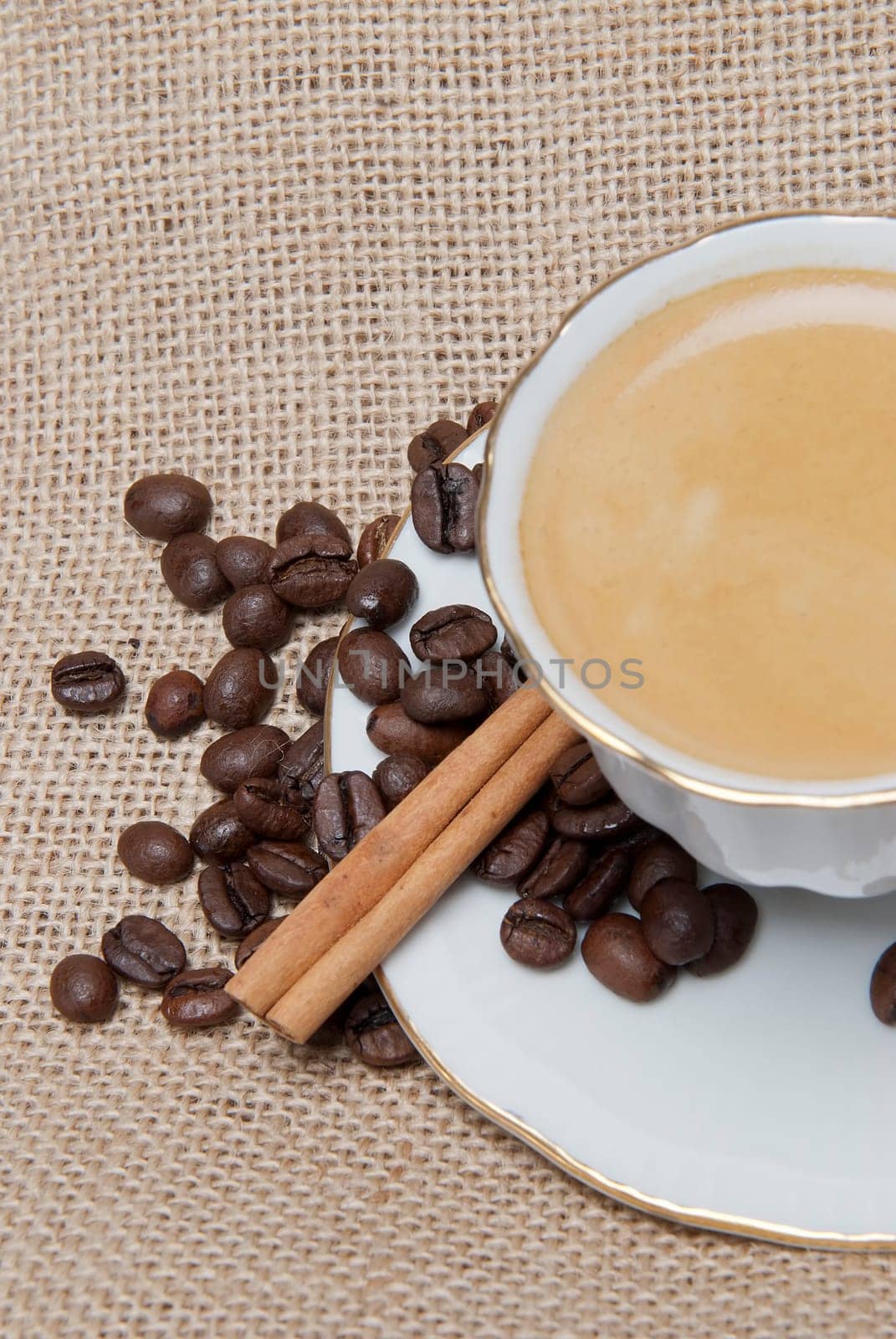 Still life about coffee with a delicious  espresso and some coffee beans and cinnamon.