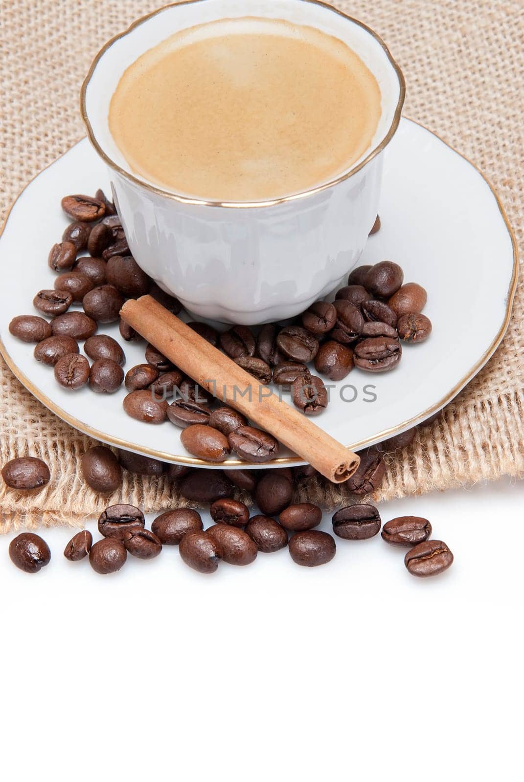 Still life about coffee with a delicious  espresso and some coffee beans and cinnamon.