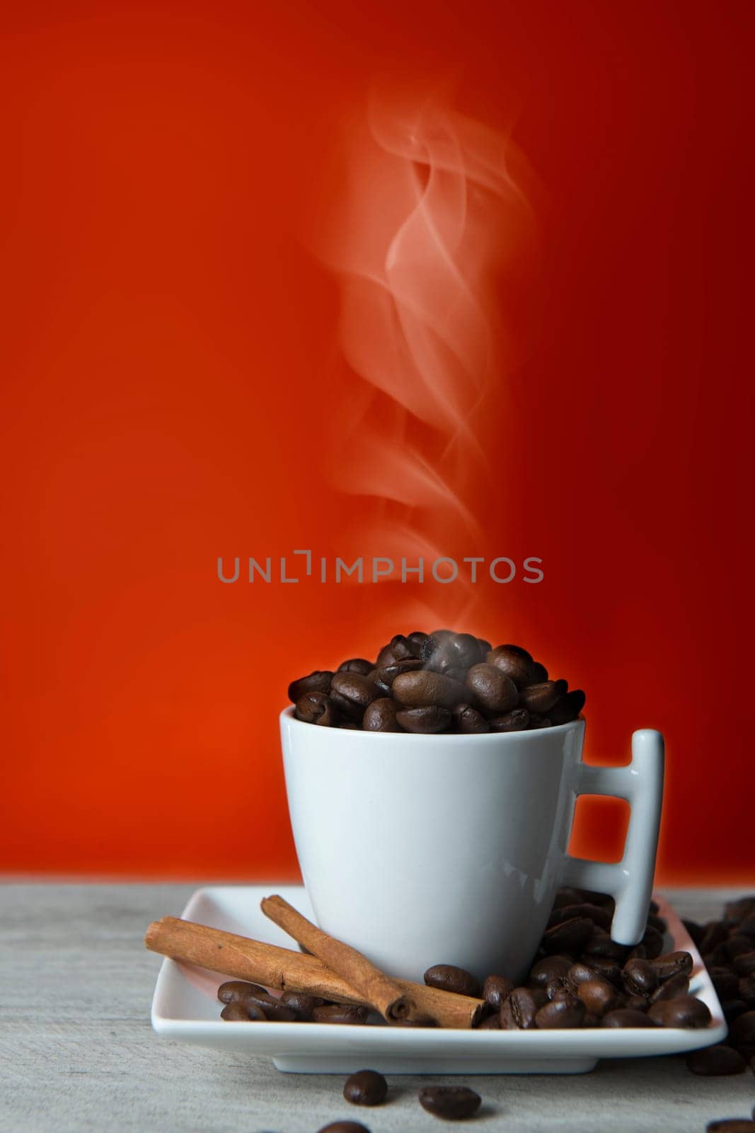 Cup full of coffee beans recently roasted and hot.