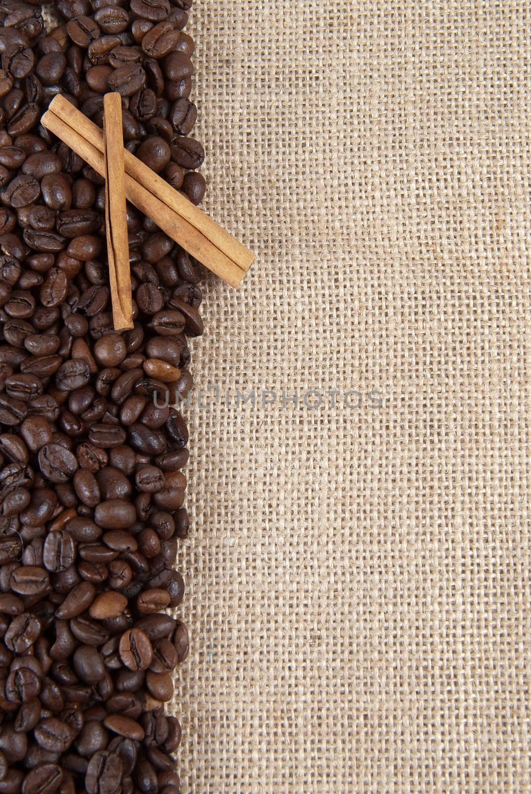 Background of burlap and coffee beans with a copy space.