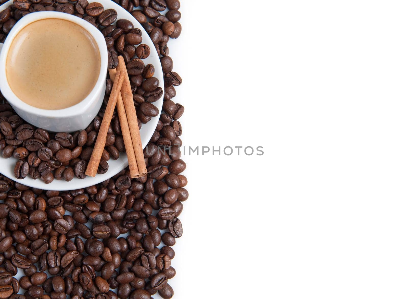 Still life about coffee with a delicious  espresso and some coffee beans and cinnamon.