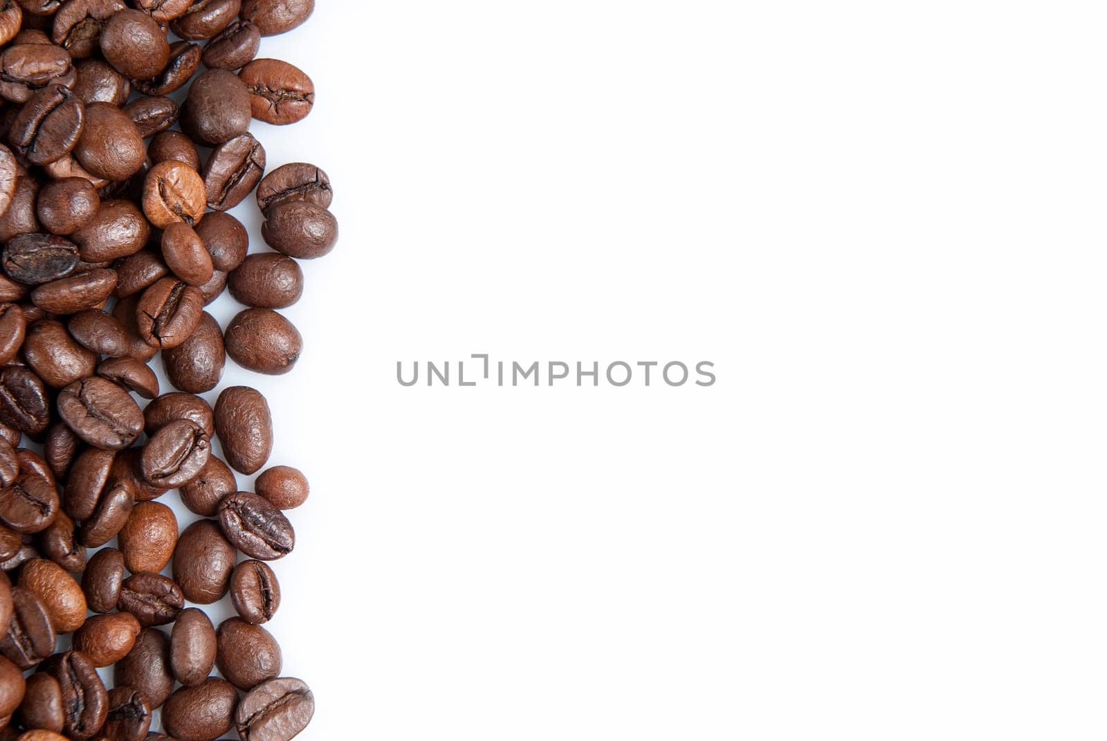 Coffee beans on a white background with a copy space.