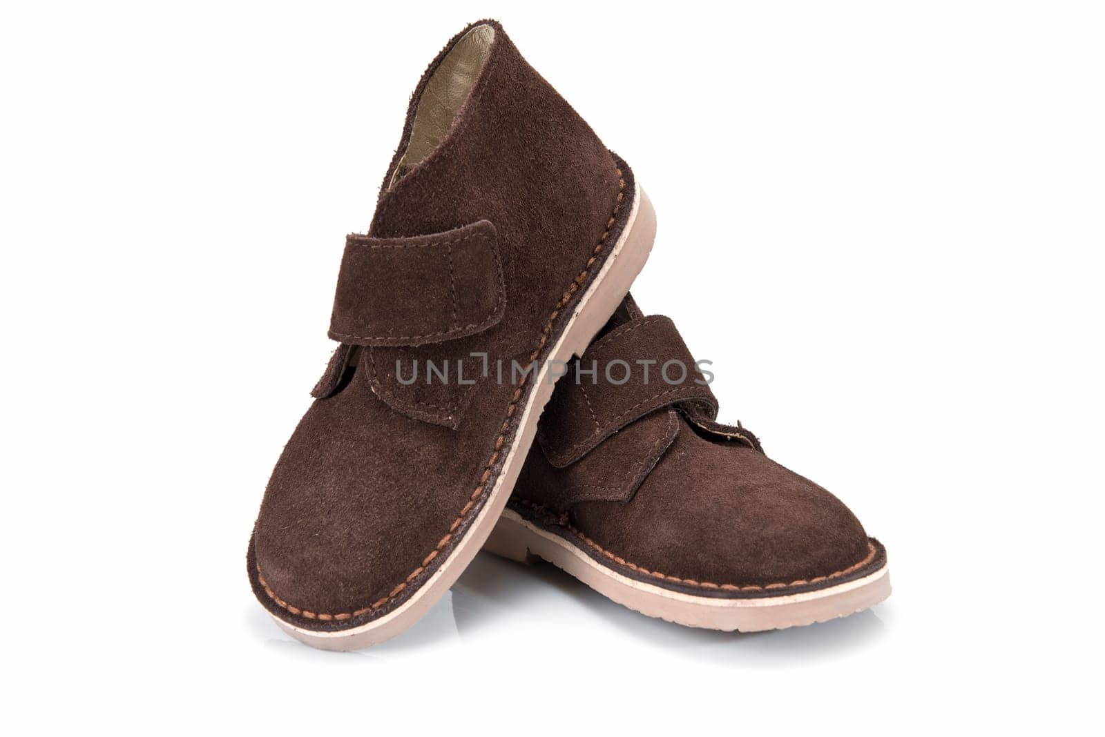 Brown leather boots for kids isolated on a white background.