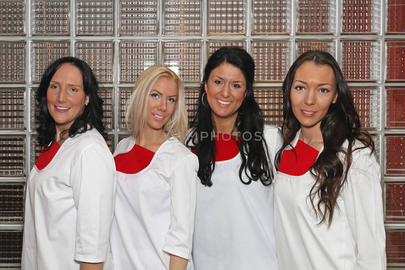 Four female doctors wearing white uniforms