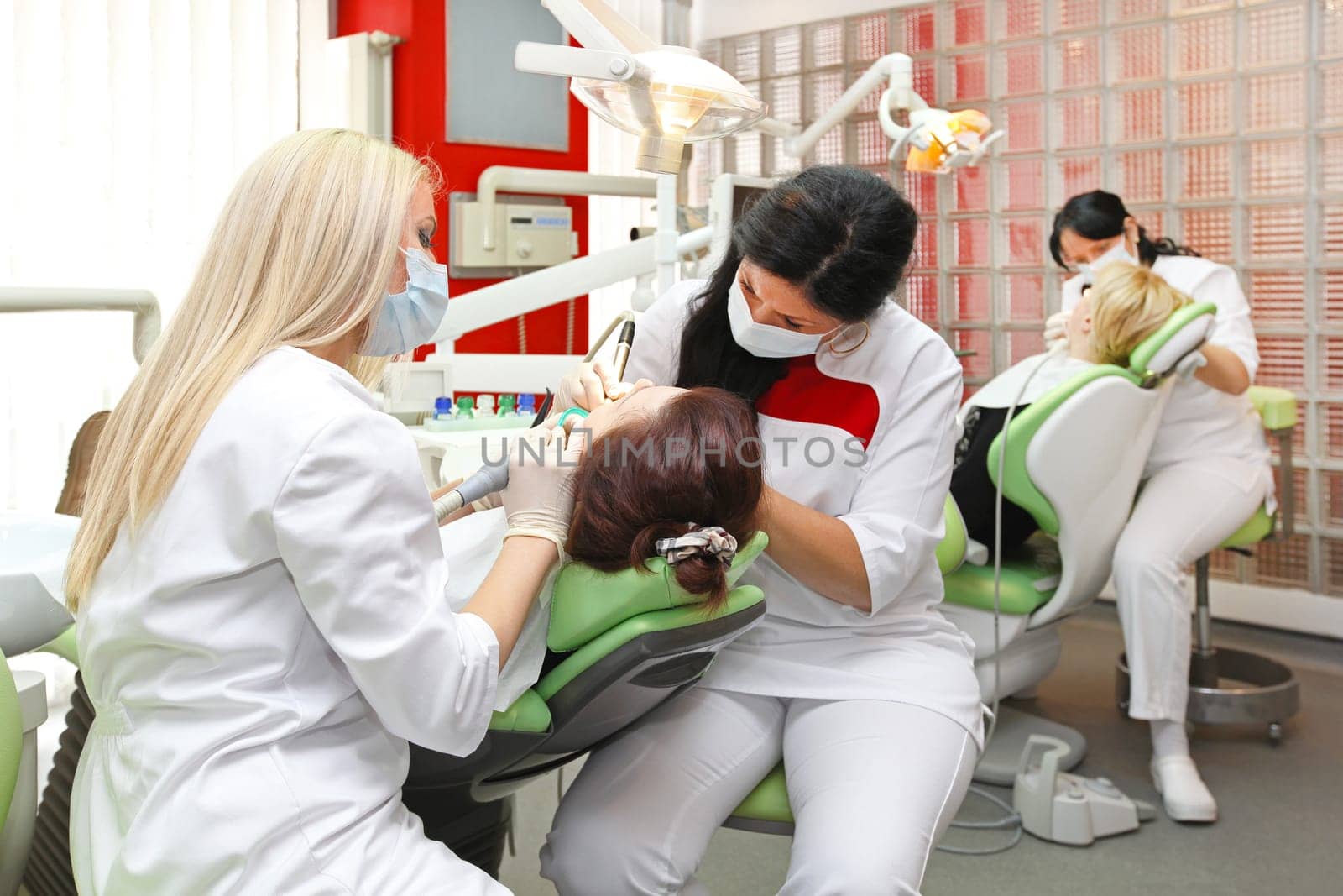 Female dentists at work in modern dental office