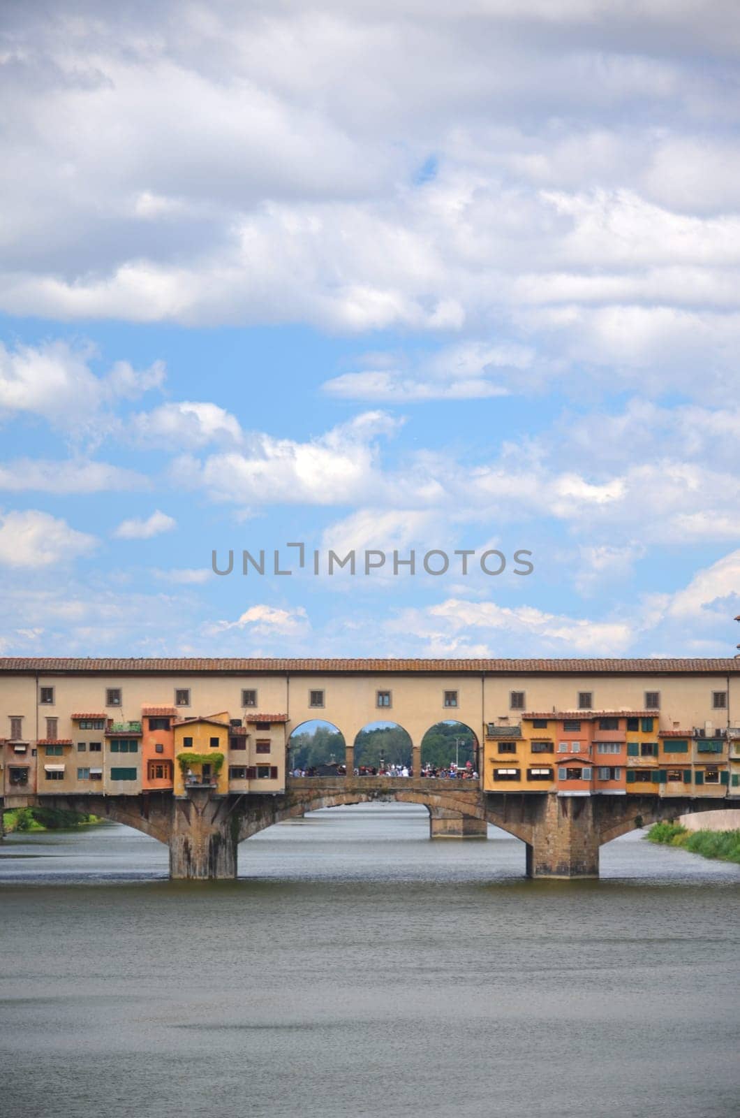 Picturesque view on colorful Ponte Vecchio over Arno River in Florence, Italy