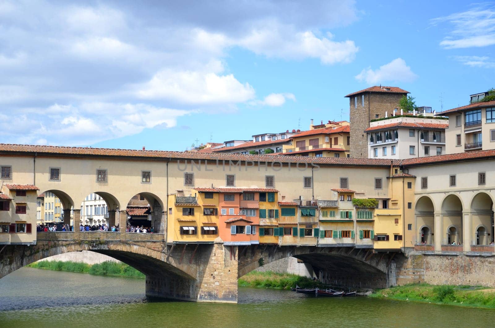 Picturesque view on colorful Ponte Vecchio over Arno River in Florence, Italy