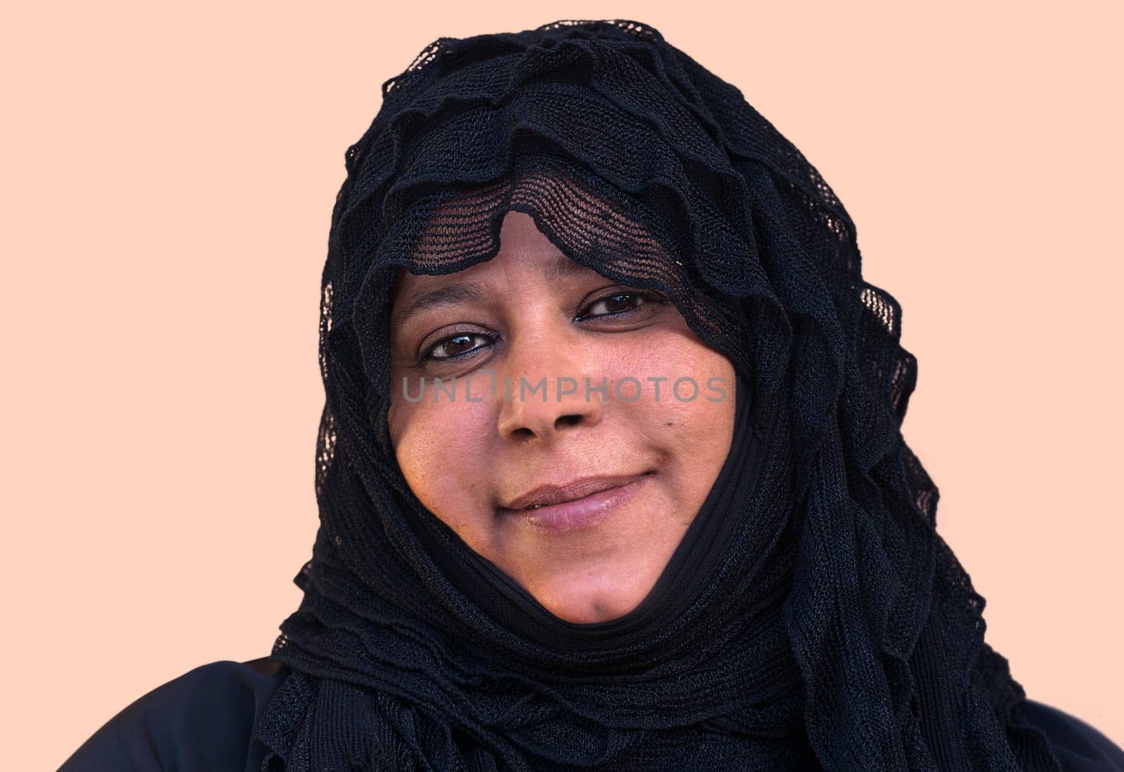 Amal with veil and with a quiet melancholic smile