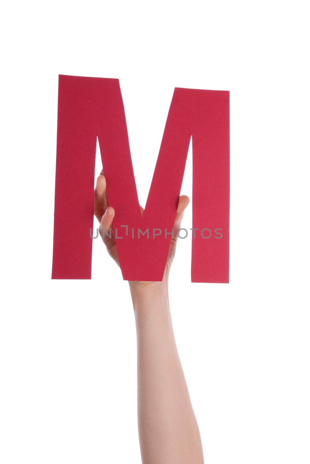 A Hand Holds the Red Letter M, Isolated