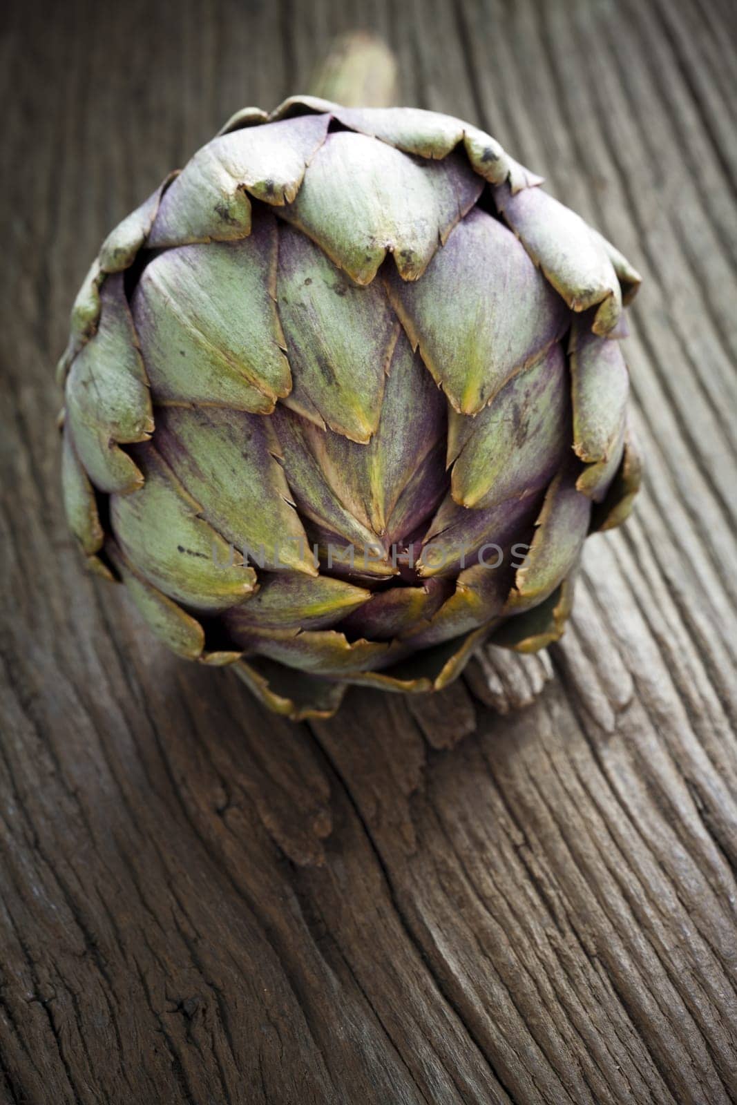 Artichoke on rustic wooden board