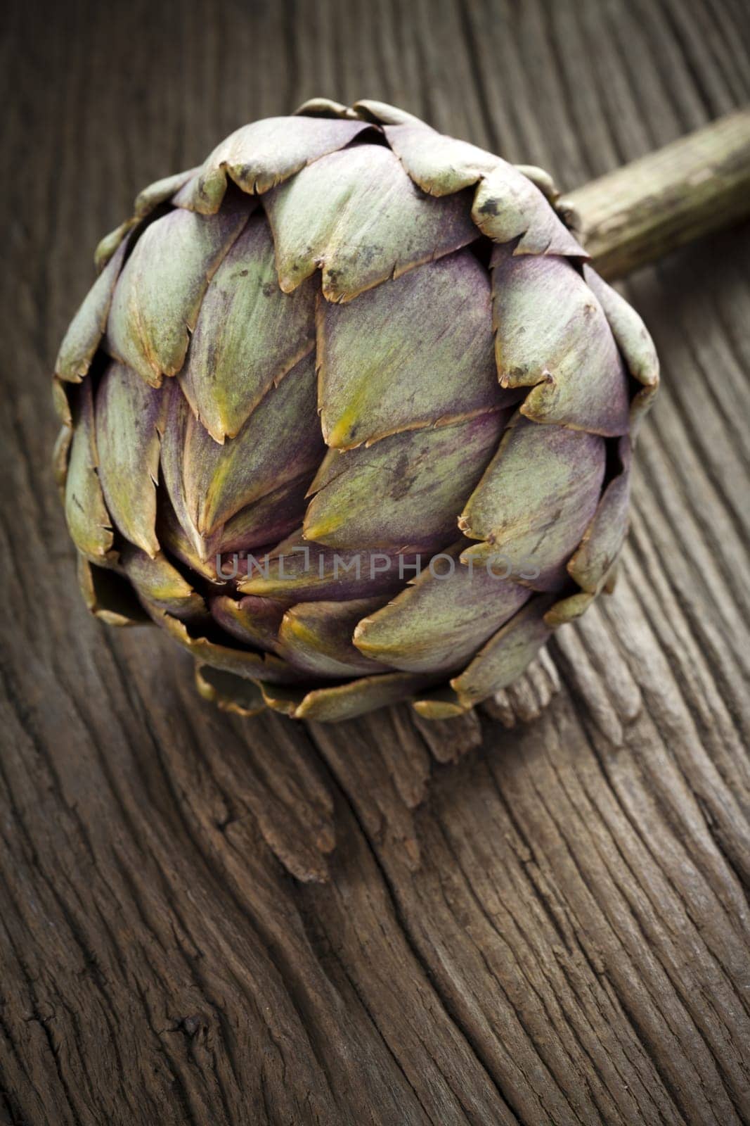 Artichoke on rustic wooden board