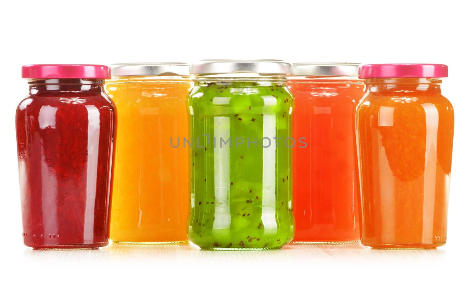 Jars of fruity jams isolated on white background. Preserved fruits