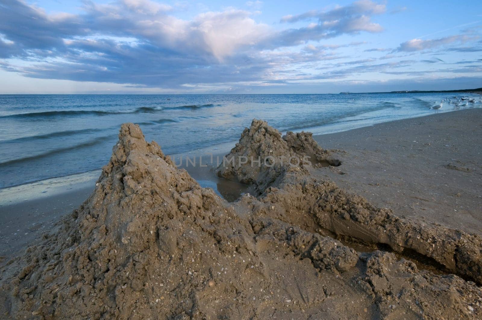 Close-up of a sandcastle at dusk on the Baltic Sea in summer