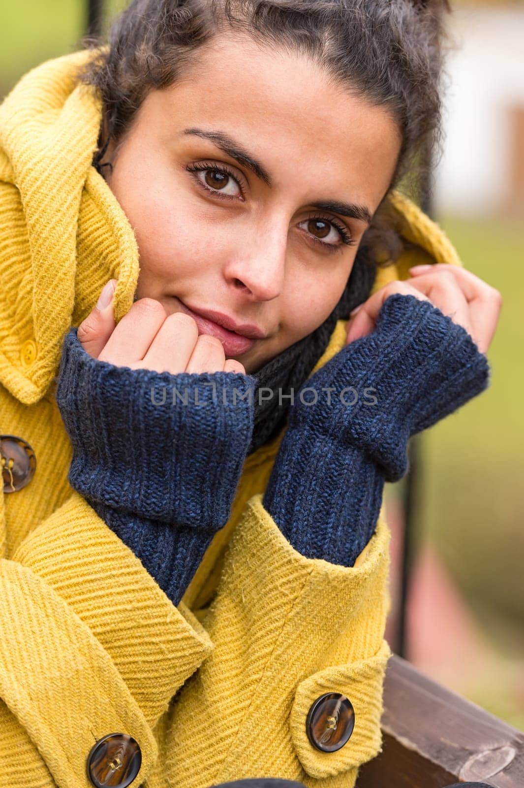 Portrait of a young woman posing with yellow coat fall