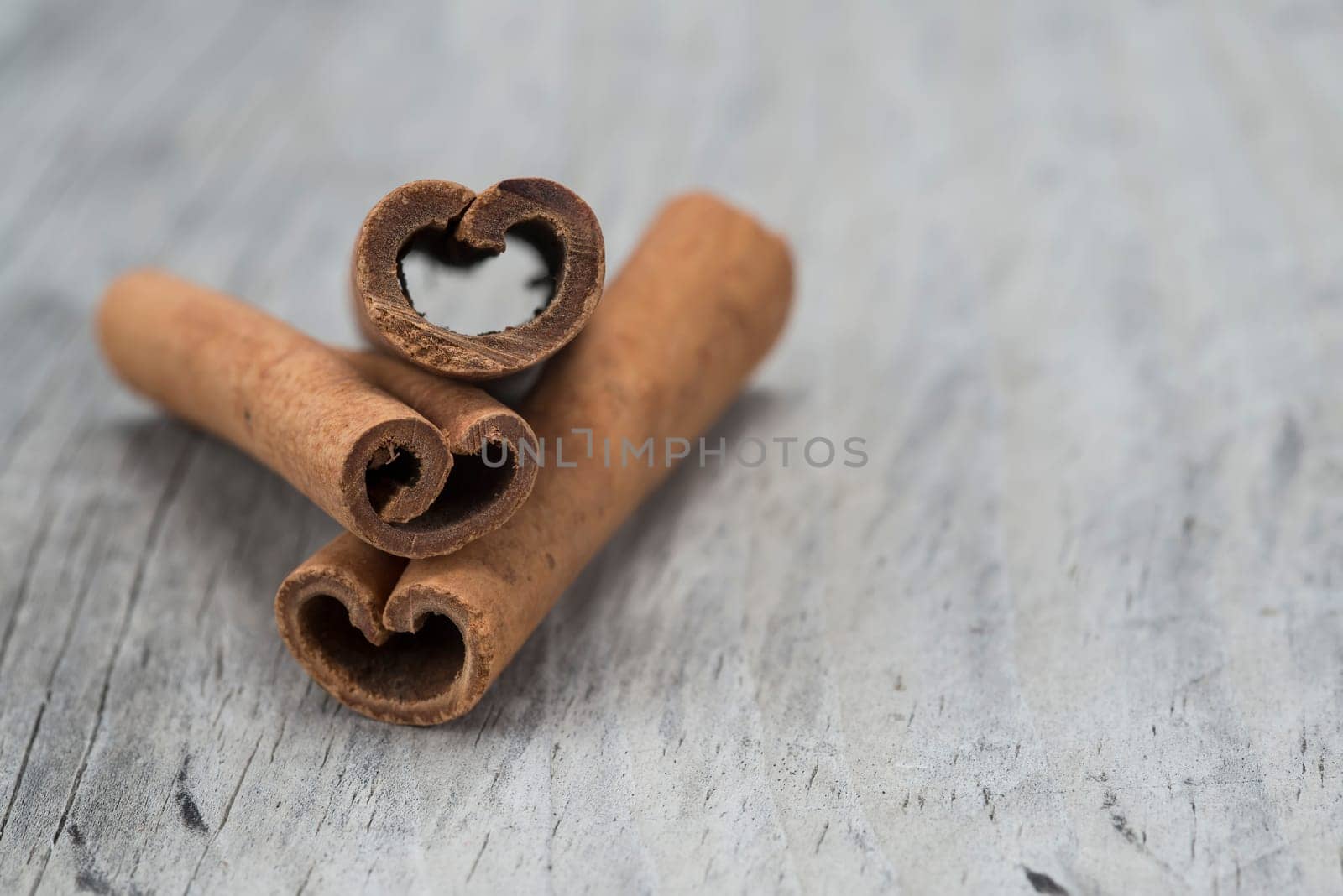 Cinnamon sticks on an old wooden table background