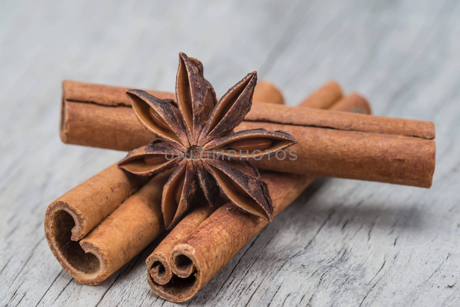 Cinnamon sticks and star anise on a wooden background