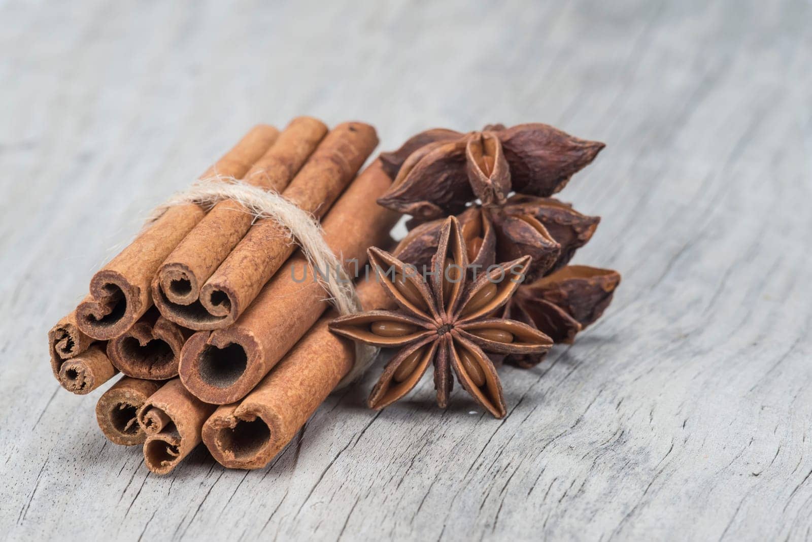 Cinnamon sticks and star anise on a wooden background