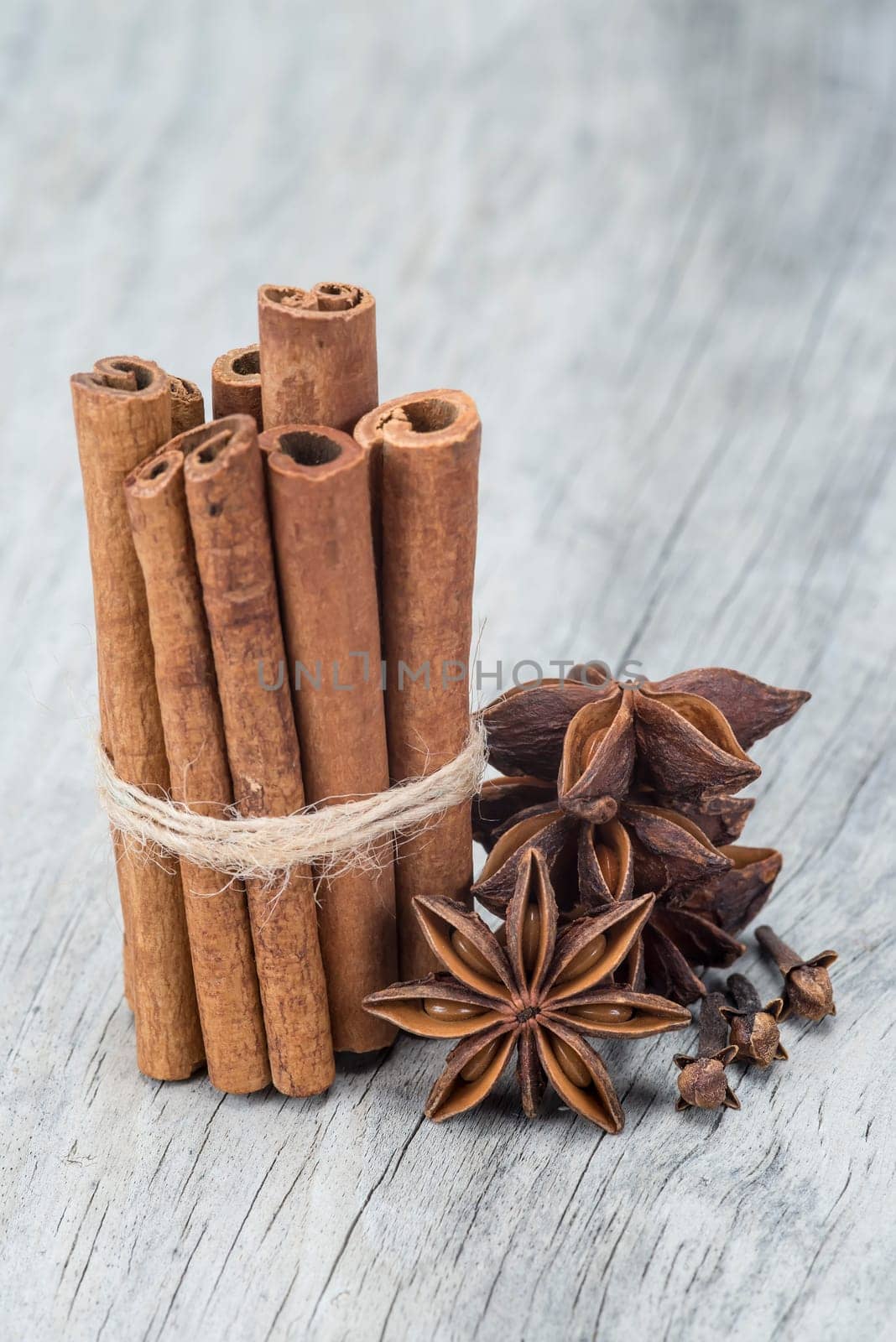 Cinnamon sticks and star anise on a wooden background