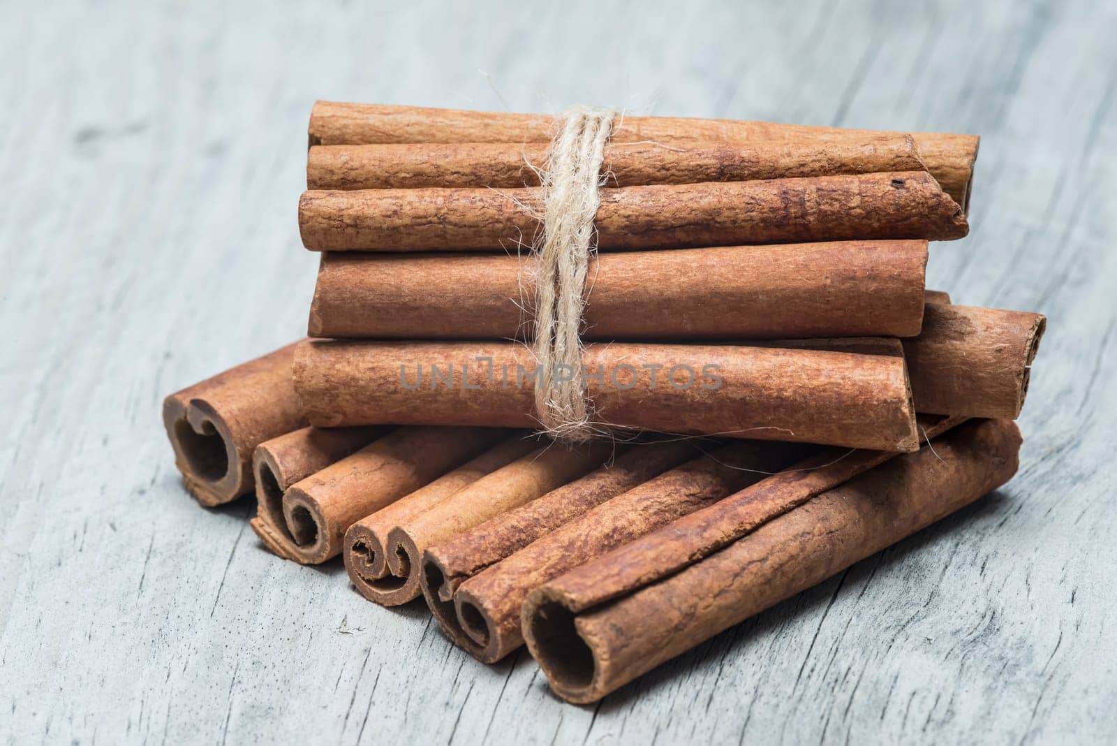 Cinnamon sticks on an old wooden table background